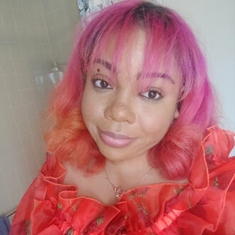Black woman with pink hair.